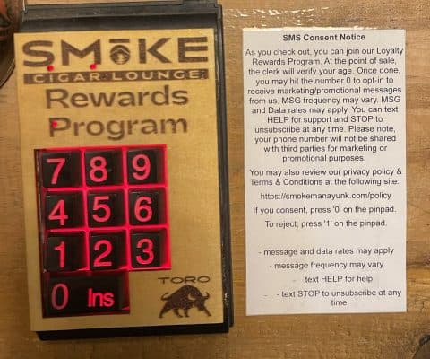 A customer-facing USB keypad (pin pad) used for SMS opt-in at the point of sale.